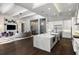 Open-concept kitchen flows into the living area, featuring a large island with marble countertops at 3428 Chaine Du Lac Blvd, Windermere, FL 34786
