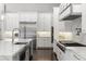 Bright kitchen with stainless steel appliances, marble countertops, and sleek white cabinetry at 3428 Chaine Du Lac Blvd, Windermere, FL 34786