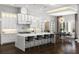 Bright, airy kitchen featuring a marble waterfall island and stainless steel appliances at 3428 Chaine Du Lac Blvd, Windermere, FL 34786