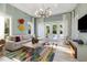 Inviting living room with a comfortable sofa, colorful decor, and views of the pool area, ideal for relaxation at 3428 Chaine Du Lac Blvd, Windermere, FL 34786
