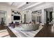 Beautiful living room features a curved couch, hardwood floors, and modern entertainment center at 3428 Chaine Du Lac Blvd, Windermere, FL 34786