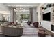 Open-concept living room with a stylish sectional sofa and views of the backyard pool at 3428 Chaine Du Lac Blvd, Windermere, FL 34786
