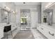 Luxurious main bathroom with dual vanities, marble accents, and a glass-enclosed shower at 3428 Chaine Du Lac Blvd, Windermere, FL 34786