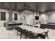An expansive outdoor living space with a fireplace, outdoor kitchen, and a long dining table for entertaining at 3428 Chaine Du Lac Blvd, Windermere, FL 34786