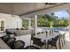 Spacious outdoor living area with a covered patio, pool, and ample seating, designed for luxurious outdoor enjoyment at 3428 Chaine Du Lac Blvd, Windermere, FL 34786