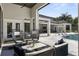 Inviting outdoor patio with comfortable seating, a pool, and a covered area, perfect for relaxation and entertaining at 3428 Chaine Du Lac Blvd, Windermere, FL 34786