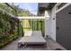 Private outdoor shower area with a lounge chair, a wood deck, and attractive greenery at 3428 Chaine Du Lac Blvd, Windermere, FL 34786