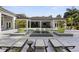 Beautiful backyard pool with inset loungers, spa, and outdoor living space, surrounded by lush greenery and mature palms at 3428 Chaine Du Lac Blvd, Windermere, FL 34786