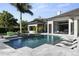 A modern pool with submerged lounge chairs and lush tropical foliage at 3428 Chaine Du Lac Blvd, Windermere, FL 34786