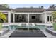 Stunning pool and spa featuring in-pool loungers and an outdoor entertainment area with a fireplace and a grill at 3428 Chaine Du Lac Blvd, Windermere, FL 34786
