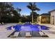 Inviting backyard pool with in-pool loungers, spa, and lush greenery for a relaxing outdoor oasis at 3428 Chaine Du Lac Blvd, Windermere, FL 34786