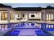 Stunning pool and spa featuring in-pool loungers and an outdoor entertainment area with a fireplace and a grill at 3428 Chaine Du Lac Blvd, Windermere, FL 34786