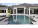 A luxurious pool with in-pool loungers, stepping stones, and an integrated hot tub at 3428 Chaine Du Lac Blvd, Windermere, FL 34786
