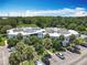 Aerial view showcasing complex, parking, landscaping with mature palm trees and well-maintained grounds at 3944 Atrium Dr # 4, Orlando, FL 32822