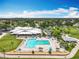 An aerial view showcasing the community pool, clubhouse, golf course, and beautiful landscaping at 3944 Atrium Dr # 4, Orlando, FL 32822