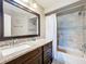 Bathroom with granite counters, dark cabinets, modern fixtures and tile shower at 3944 Atrium Dr # 4, Orlando, FL 32822