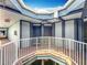 Outdoor view of a covered walkway of the building with brick flooring and metal railings at 3944 Atrium Dr # 4, Orlando, FL 32822