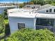 Exterior view of building featuring a screened-in porch, siding, and flat roof with AC units at 3944 Atrium Dr # 4, Orlando, FL 32822