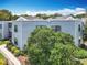 Exterior view of the complex, showcasing its light blue siding and manicured landscaping at 3944 Atrium Dr # 4, Orlando, FL 32822