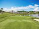 Beautiful golf course with well-maintained green, mature trees, and a view of the clubhouse and pool area at 3944 Atrium Dr # 4, Orlando, FL 32822