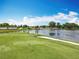 Golf course aerial view of the putting green with the lake, pool, and clubhouse in the background at 3944 Atrium Dr # 4, Orlando, FL 32822