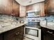 Modern kitchen with granite countertops, stainless steel appliances and a stylish tile backsplash for easy cleaning at 3944 Atrium Dr # 4, Orlando, FL 32822