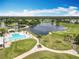 Beautiful sunny aerial view of the golf course, lake, and community pool with lush landscaping at 3944 Atrium Dr # 4, Orlando, FL 32822