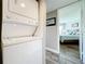 In-unit laundry featuring stacked washer and dryer near the primary bedroom and an attached ensuite bathroom at 3944 Atrium Dr # 4, Orlando, FL 32822
