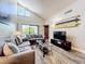 Cozy living room with a large window, comfortable seating, and modern decor provides a relaxing and stylish atmosphere at 3944 Atrium Dr # 4, Orlando, FL 32822