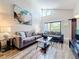 Bright living room features two couches and a sliding glass door, as well as a piece of abstract art on the wall at 3944 Atrium Dr # 4, Orlando, FL 32822