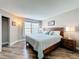 Comfortable main bedroom offers a wood headboard, wood-look flooring and natural light from the window at 3944 Atrium Dr # 4, Orlando, FL 32822