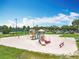 Neighborhood playground with slides and swings surrounded by grassy areas and trees at 3944 Atrium Dr # 4, Orlando, FL 32822