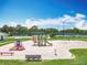 Community playground featuring slides, swings, and a covered picnic table at 3944 Atrium Dr # 4, Orlando, FL 32822