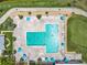 Aerial view of the large community pool featuring plenty of lounge chairs and tables with umbrellas at 3944 Atrium Dr # 4, Orlando, FL 32822