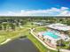 An aerial view showcasing the community pool, clubhouse, and scenic golf course with lush landscaping at 3944 Atrium Dr # 4, Orlando, FL 32822