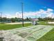 Shuffleboard courts next to other activity areas in a community park, with lighting for evening games at 3944 Atrium Dr # 4, Orlando, FL 32822