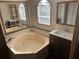 Bathroom with a tub, white sink, and light-yellow painted walls at 622 Dreama Dr, Davenport, FL 33897