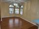 Inviting dining area featuring wood floors, natural light from windows, and a decorative chandelier at 622 Dreama Dr, Davenport, FL 33897