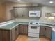 Well-appointed kitchen featuring gray cabinetry, modern appliances, laminate counters, and plenty of storage space at 622 Dreama Dr, Davenport, FL 33897
