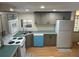 Bright kitchen with gray cabinets, stainless steel appliances, laminate countertop, and wood-look flooring at 622 Dreama Dr, Davenport, FL 33897