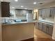 A spacious kitchen with stylish gray cabinets, modern appliances, laminate countertops, and hardwood floors at 622 Dreama Dr, Davenport, FL 33897