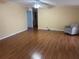 Spacious living room with a ceiling fan, wood floors, and neutral walls at 622 Dreama Dr, Davenport, FL 33897