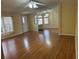 Open-concept living room featuring laminate flooring, a ceiling fan, and lots of natural light from large windows at 622 Dreama Dr, Davenport, FL 33897
