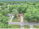 Bird's eye view of the home nestled amongst lush trees and greenery in a quiet neighborhood at 6421 Nw 61St St, Ocala, FL 34482