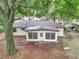 Aerial view of backyard featuring mature trees and a sunroom on the house at 6421 Nw 61St St, Ocala, FL 34482