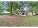 The backyard has a mature shade tree, and access to the house through the enclosed porch at 6421 Nw 61St St, Ocala, FL 34482