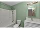 Bathroom has a shower-tub combo, large mirror and vanity with storage at 6421 Nw 61St St, Ocala, FL 34482