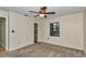 Bright carpeted bedroom featuring a ceiling fan and a window with natural light at 6421 Nw 61St St, Ocala, FL 34482