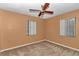 Bedroom with carpet flooring, ceiling fan, and natural light from two windows at 6421 Nw 61St St, Ocala, FL 34482