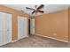 Cozy bedroom with carpet, ceiling fan, and a closet for storage at 6421 Nw 61St St, Ocala, FL 34482